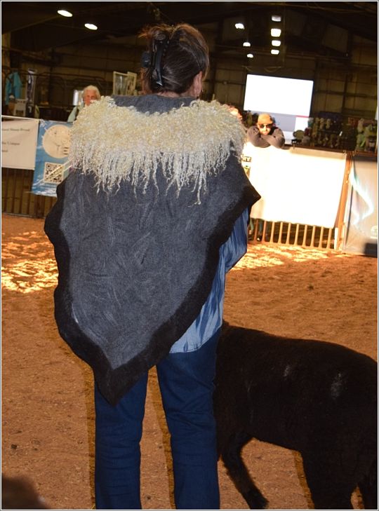 Teresa Beatty models her wet- and needle-felted cape that was awarded Fiber Arts Best Quality of Felting Entry. She wet-felted Merino with a Corriedale border and needle-felted Teeswater locks in to the collar. Clay buttons hand made by Mud Buttons. Photo: Peggy Lundquist.